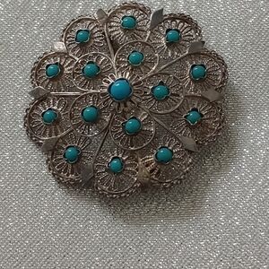 Intricate Silver Brooch with Turquoise Details